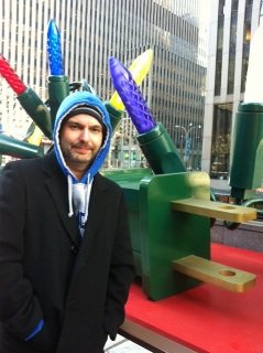 Greg in front of enormous Christmas lights at Rockefeller Center in NYC