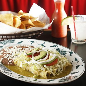 At Las Delicias, the popular Enchilada Verdes is smothered in tomatillo salsa and topped with sliced avocado.