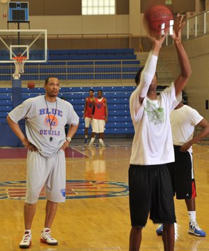 Marcus Brown (left) coaching the West Memphis High School Blue Devils basketball team.