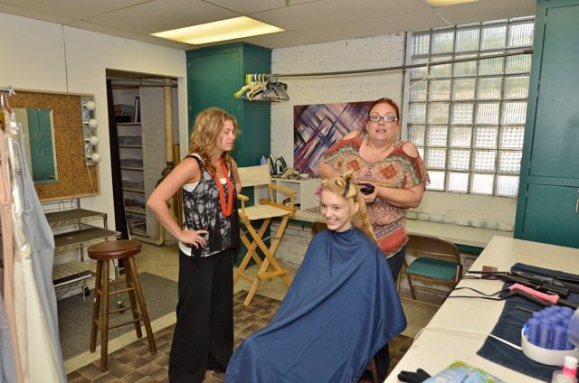 Meg (seated) getting crimped by hair magicians, Alyx (L) and Mary (R).