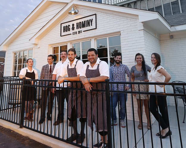 Andrew Ticer and Michael Hudman in front of Hog &amp; Hominy with the establishment's management and culinary leaders.