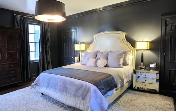 Mirrored surfaces in the master bedroom show off its glamorous shades of lilac, grey, and white.