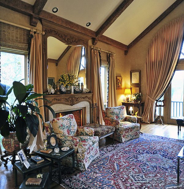 Distressed wooden beams add texture and rusticity to the gand living room with its elegant draperies and furnishings.
