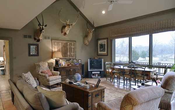 The comfortable family room offers wonderful outdoor vistas and displays three hunting trophies (gemsbok, caribou, and waterbuck).