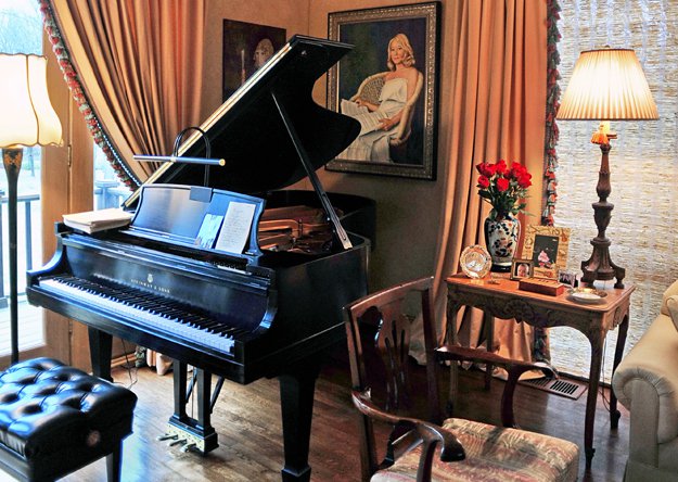 A Steinway grand piano is the dramatic focal point of the Evans' living room.