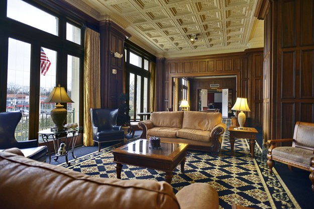The handsome lobby with original walnut paneling and hand-carved ceilings offers a grand welcome as it has for 90 years.