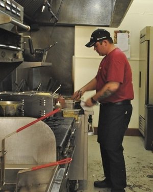 Cortona Chef Nate Olivia, a former chef de cuisine at Erling Jensen, cooks in his new kitchen in Cooper-Young.
