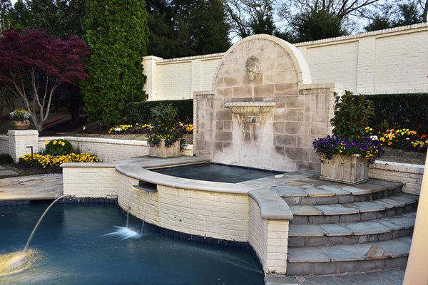 Eliminating drapes and replacing small-paned windows opened up the backyard  view of this fabulous fountain and pool.