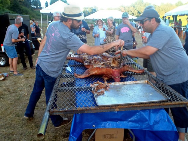 Chefs Andy Ticer and Michael Hudman go Hog Wild in Oregon; so does chef Felicia Willett, below, touring Elk Cove Winery, where the pig roast was held Saturday.