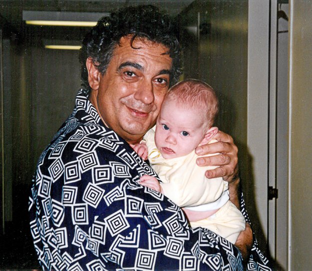 Her good friend and colleague Placido Domingo cradles Esperian’s infant son John, 1993.