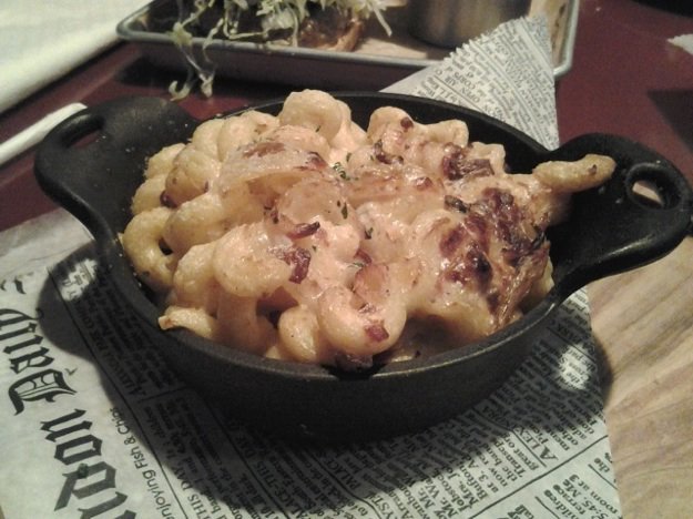 The mac 'n cheese at Fox and Hound combines Cavatappi pasta, caramelized onions, and bacon with beer-cheese sauce. Parmesan makes a crusty topping.