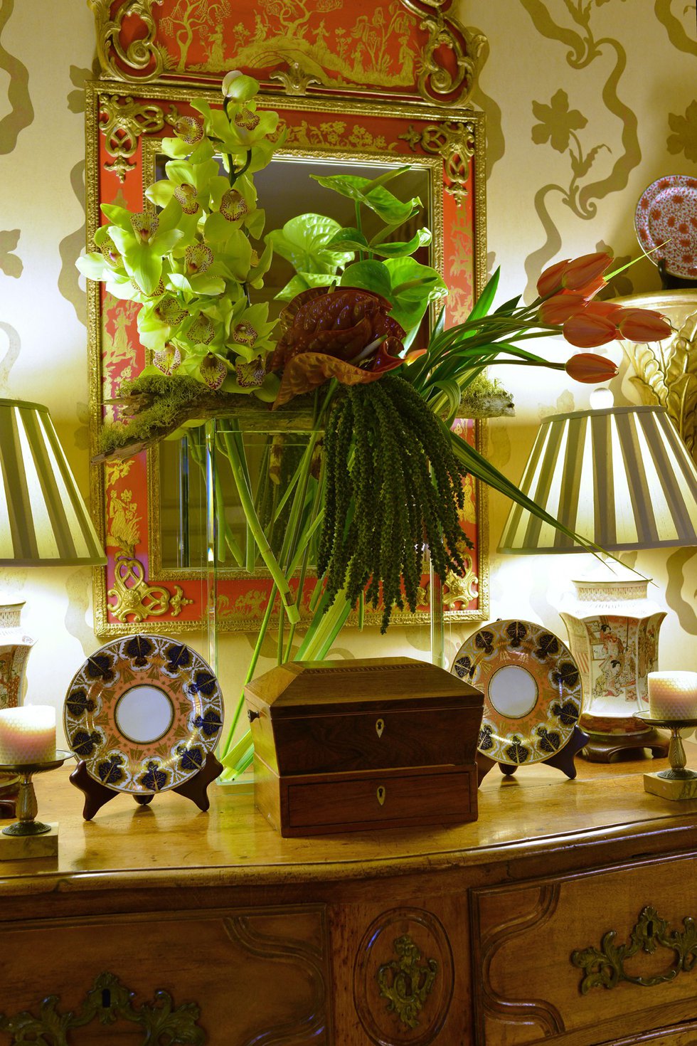 The table-top floral arrangement in the entry of Russell’s home is a vivid welcome to visitors, and its colors harmonize with the dining room display.