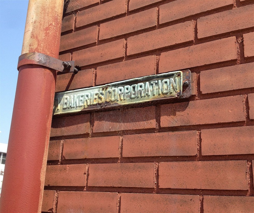 Now tucked behind a drainpipe, this old sign once marked the site of a Purity Bakeries operation.