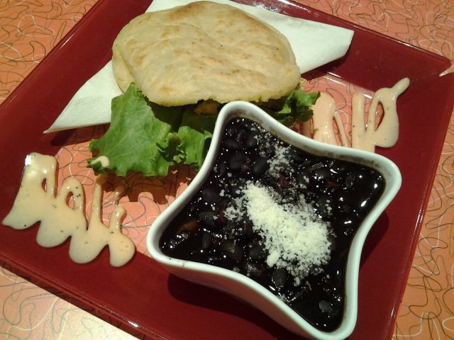 A shredded chicken arepa with a side of black beans gets a pretty plate at Arepa &amp; Salsa on Madison Avenue.
