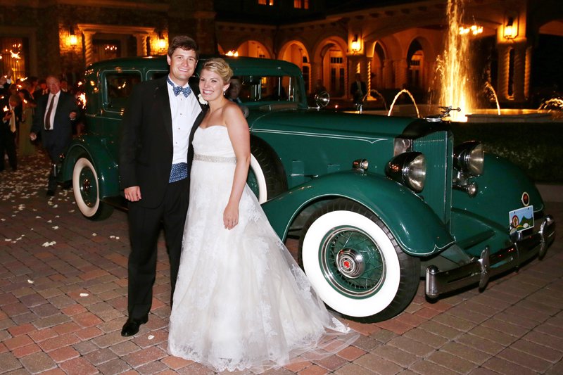 The bride and groom prepare to depart the fabulous reception in a Packard Super Eight.