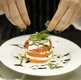  A chiffonade of basil is the finishing touch on the team’s Caprese Tower Salad.
