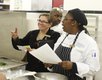 Professor Carol Silkes directs and encourages students as they make their way through the process of preparing a meal for the judges.