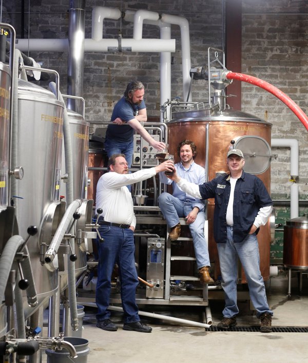 Mike Lee, Brice Timmons, Ross Avery, and Ryan Staggs raise a glass inside High Cotton.