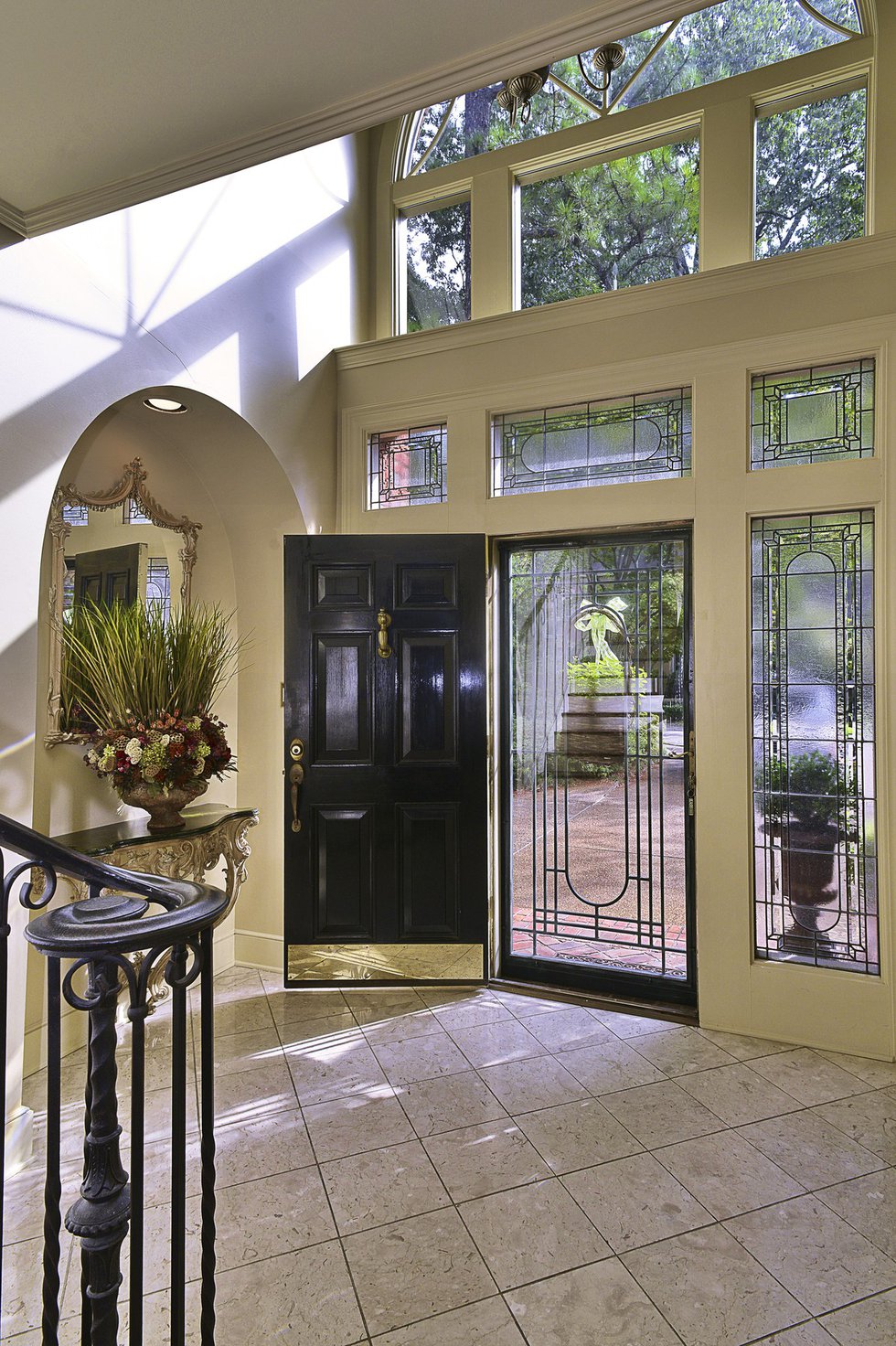 Elaborate fenestration including leaded glass windows make quite an entrance.