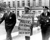 Carrying a hand-painted cardboard sign, a protestor maintains a solitary vigil outside the Courthouse in the days following King’s death.