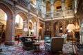 Among Highclere’s most recognizable rooms is the saloon, a Gothic-style entertaining parlor paneled in 17th-century Spanish leather and featuring triple height ceilings that soar 50 feet. It is the physical and social heart of the house.