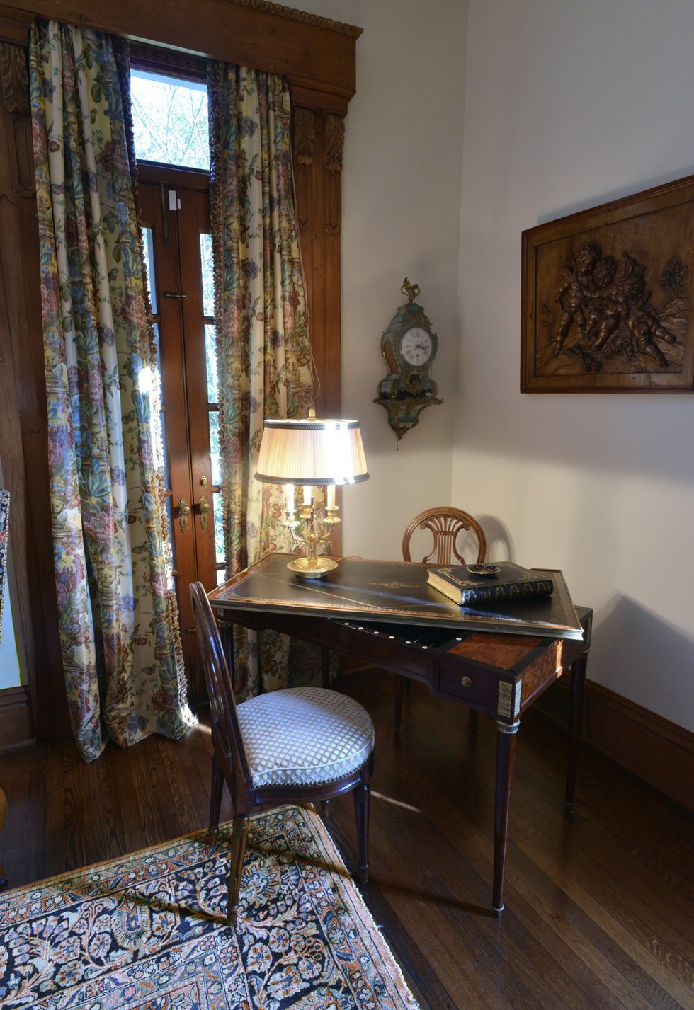  An antique French tric-trac table, created for a game similar to backgammon, is the focal point of this corner of the living room.