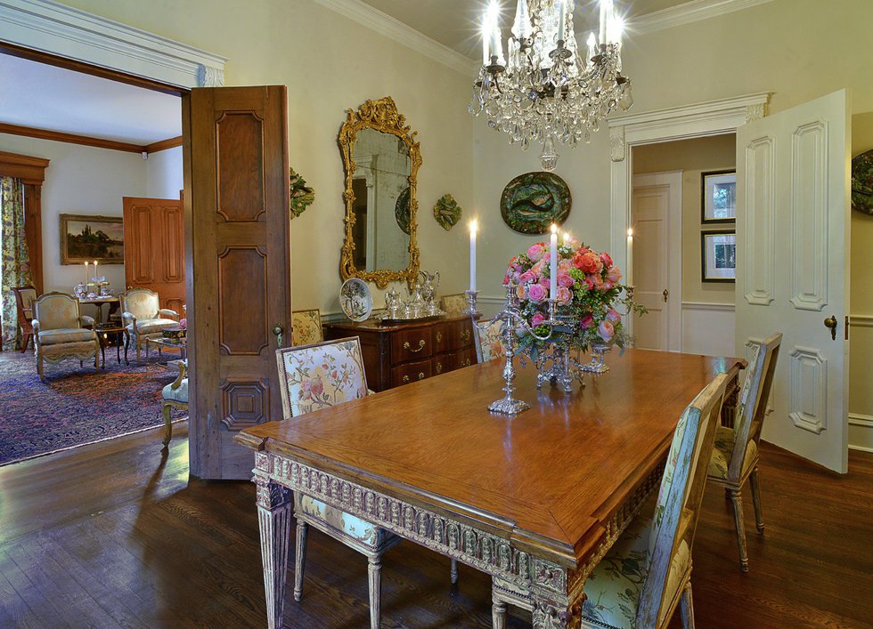 The dining room is chock full of “important” pieces, including the collection of palissy ware on the walls and the nineteenth-century silvered-bronze and crystal chandelier based on a Versailles model. The table and chairs were custom-made by Nancy Cor...