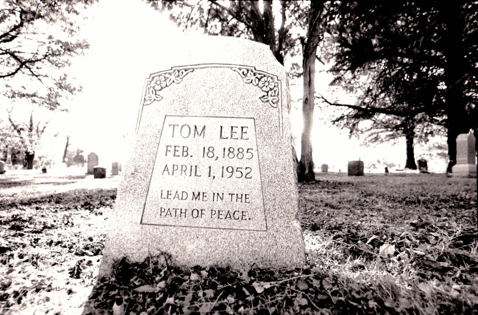 Tucked away in a shady section of Mt. Carmel Cemetery, the burial site of Tom Lee makes no mention of the Norman disaster.