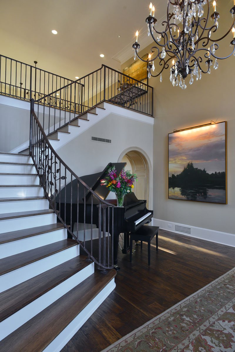 The chandelier in the entrance hall provides an elegant welcome to the home, and the leaf motif on the wrought-iron banister is in perfect keeping with the home’s rural setting in eastern Shelby County.
