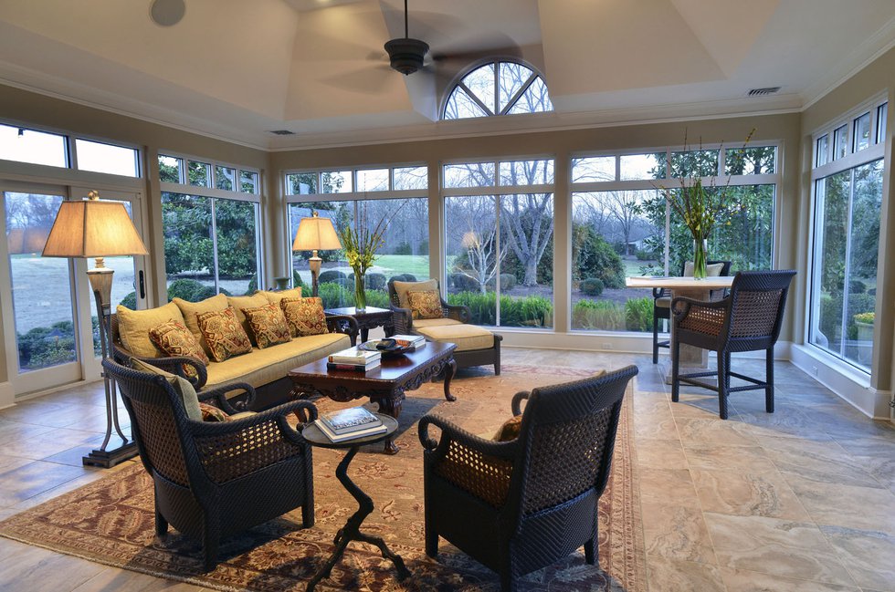 The large first-floor garden room brings the outside in and features comfortable seating by Century Furniture.
