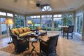 The large first-floor garden room brings the outside in and features comfortable seating by Century Furniture.
