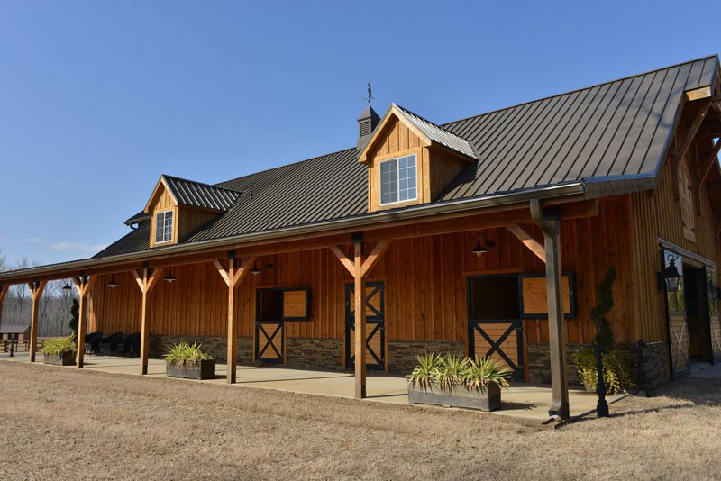 Designer Ami Austin says, “You could eat off the floor” of these handsome stables built by the Malones.