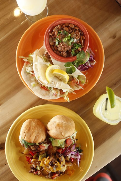 Popular dishes at Cafe Ole include fish tacos and carnitas tortas layered with roast pork, avocado, and chile del arbol sauce on Mexican rolls called bolillos.