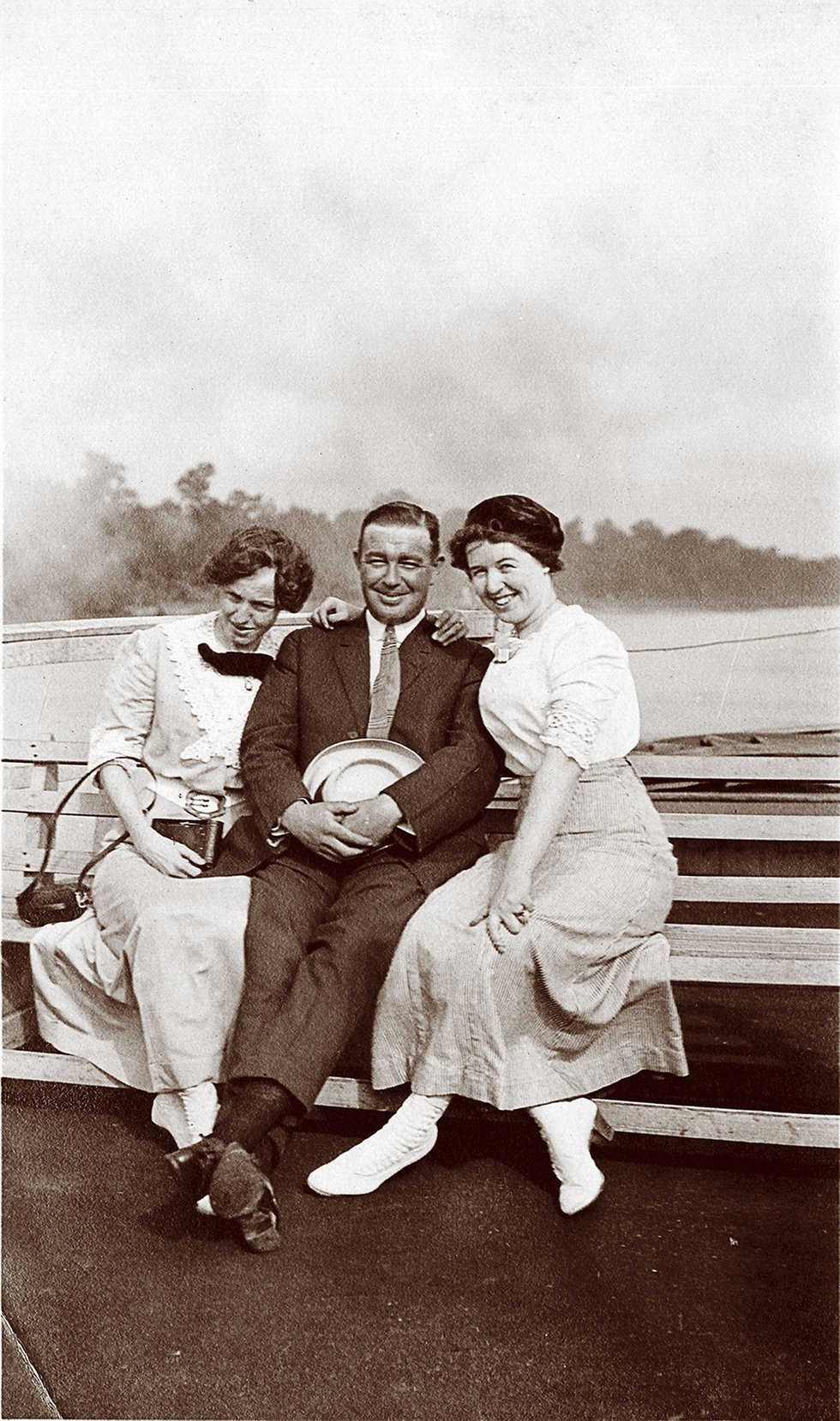 The caption says it all: “Contented: Lena, Joe, Agnes.” That’s Joe Bennett in the center, in this tranquil boating scene.