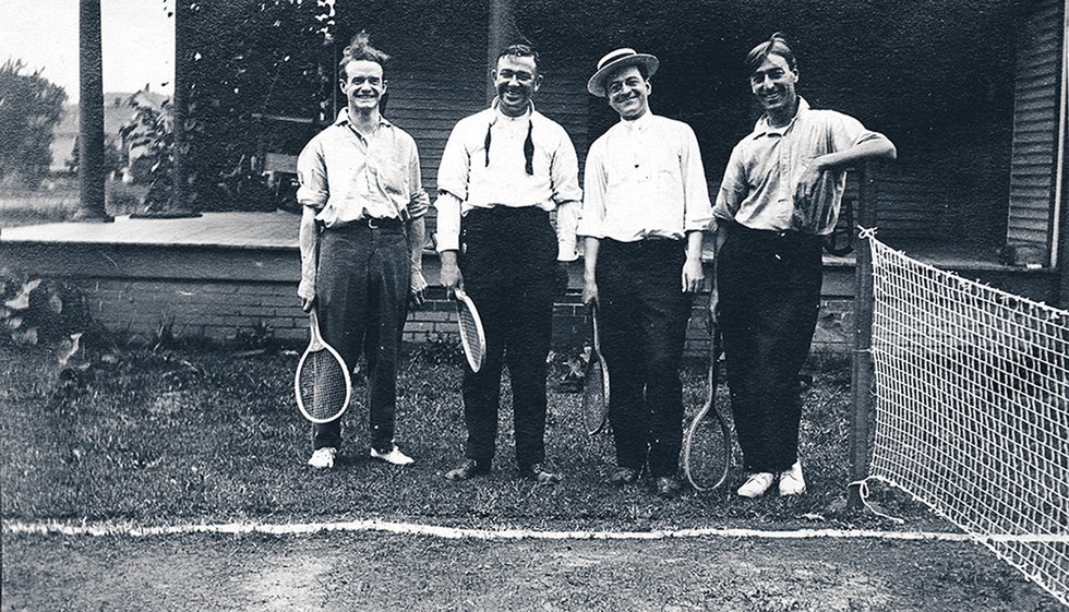 Then as now, a tennis match was a good way to spend a summer afternoon. Joe Bennett stands second from the left; the other players are unknown.
