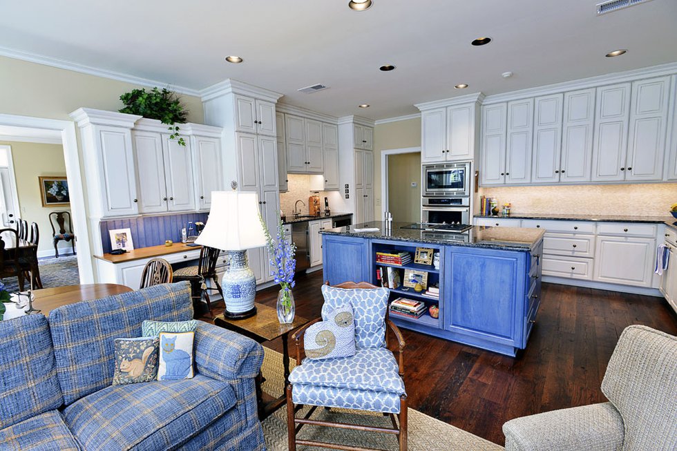 The open-plan kitchen and morning room show off Cannon’s passion for the classic decorative combination of blue and white — in cabinetry, fabrics, and porcelain. 