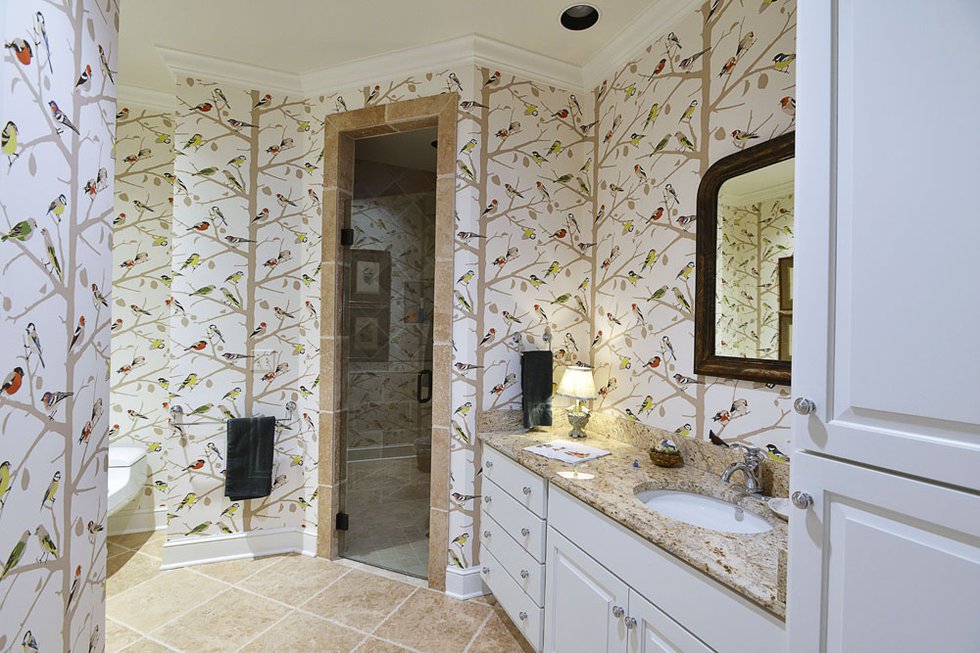 A brightly colored and all-over patterned bath resembles nothing so much as a lovely aviary (that’s birds!) — one of Cannon’s favorite motifs for their home.
