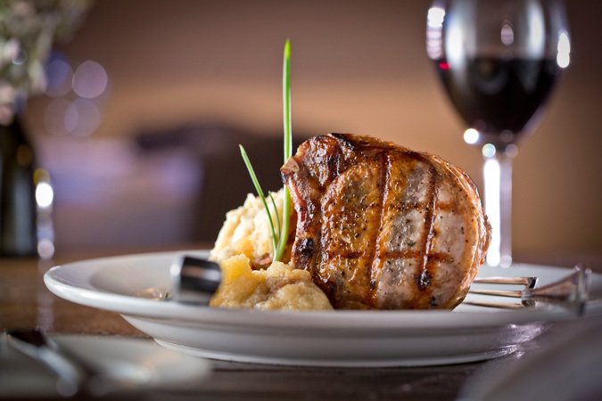 Robust and satisfying, Napa’s dry-aged porterhouse chop is served with roasted Granny Smith apple sauce, apple ginger demi-glace, and smoked bacon and blue cheese mashed potatoes. Owner Glenda Hastings, managing partner Rusty Prudhon, and Chef Ken Lu...