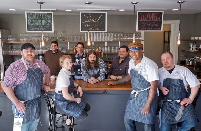 Andrew Ticer and Michael Hudman, center, with the staff at their new restaurant and butcher shop  called Porcellino’s. Small plates from Porcellino’s are pictured below.