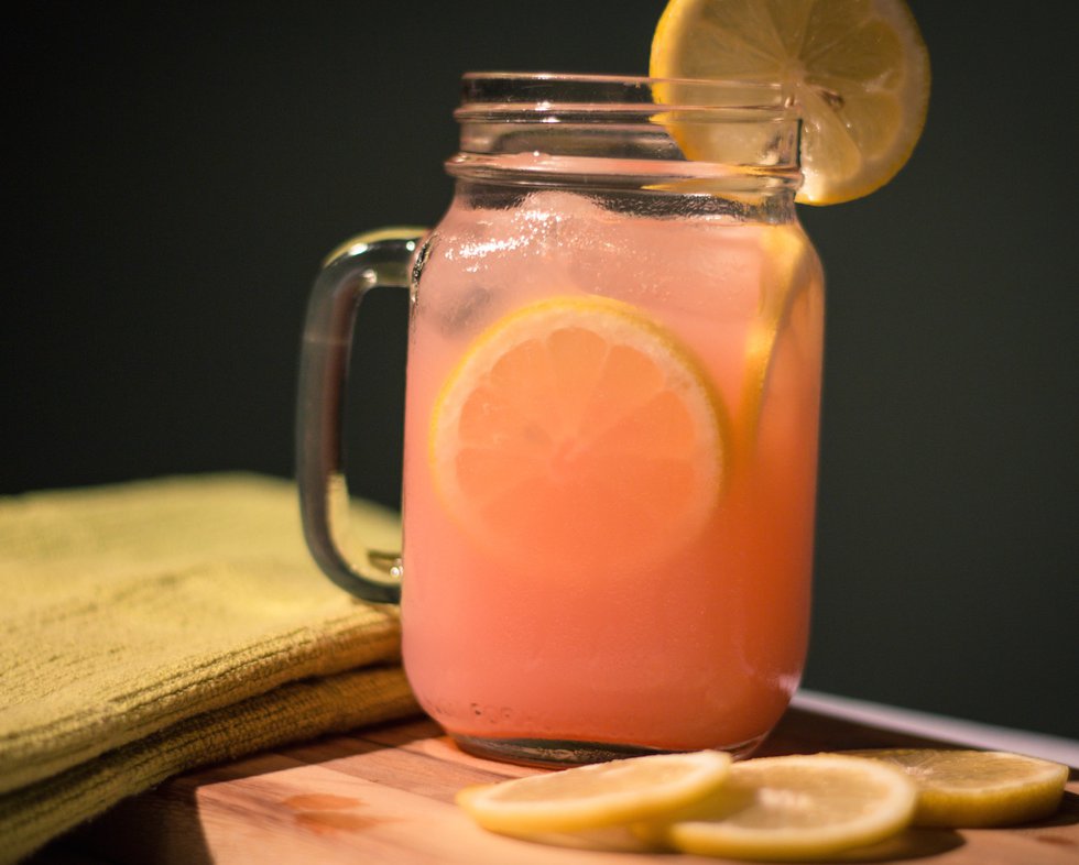 The Pink Kitty tastes best in a Mason jar mug garnished with lots of lemon slices.